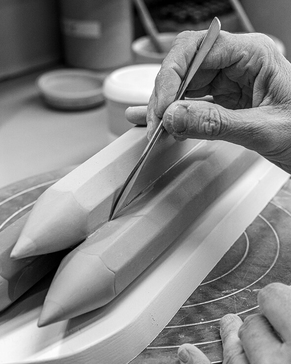 Artist painting porcelain detail