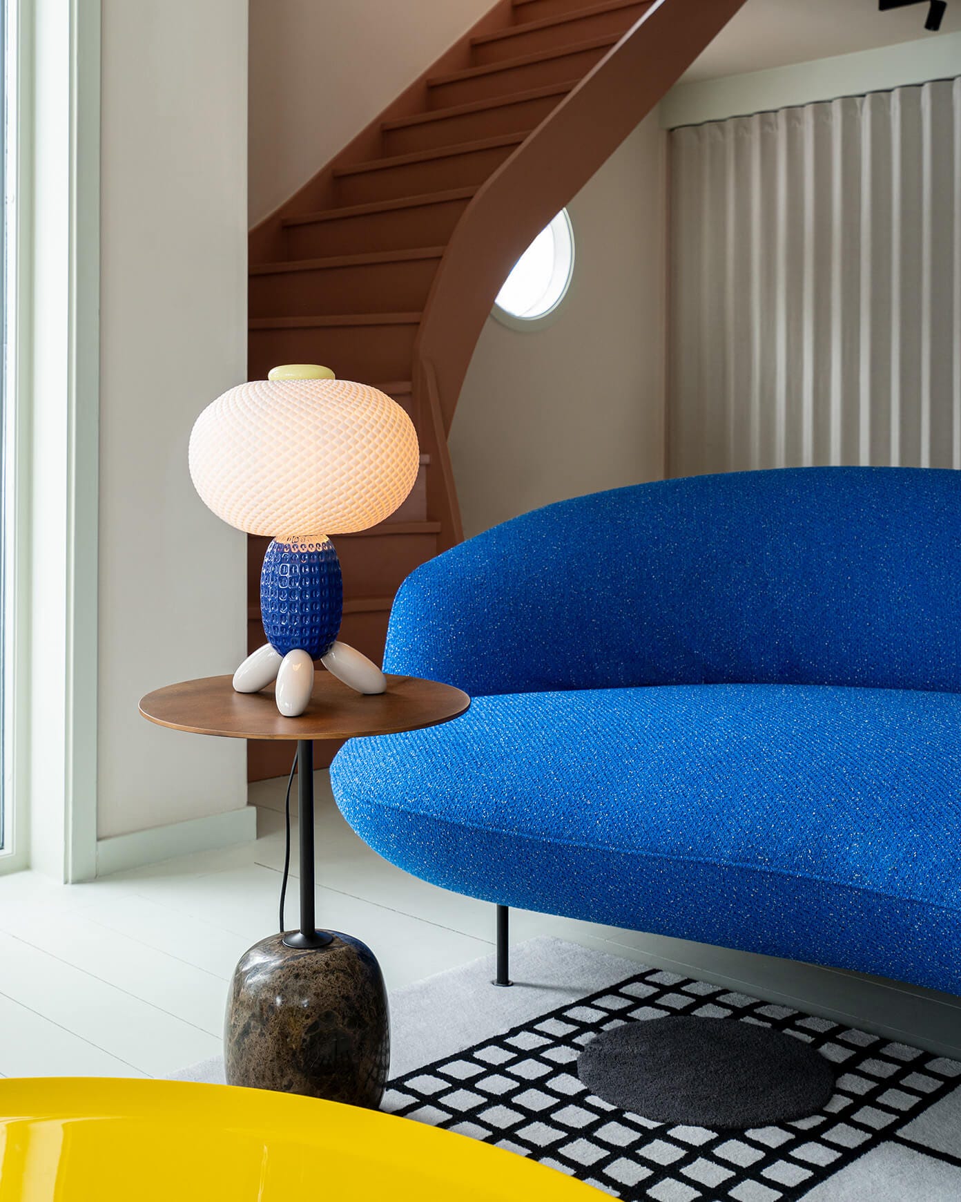 Yellow Soft Blown table lamp decorating a modern reading nook