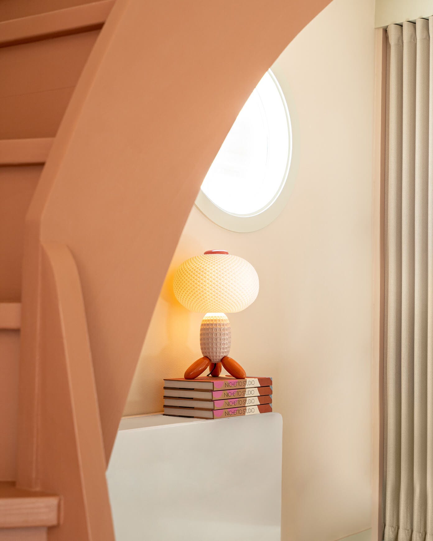 Pink Soft Blown table lamp decorating a modern reading nook